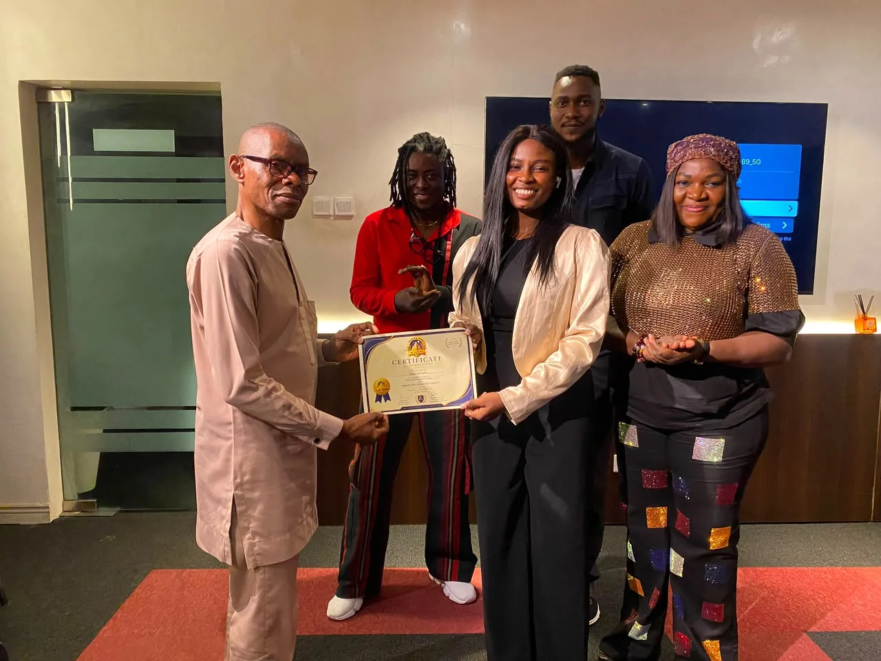 Certificate presentation with faculty members and a filmmaker